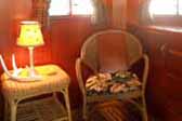 Wicker chairs and designer furnishings in restored 1938 Kozy Coach Trailer